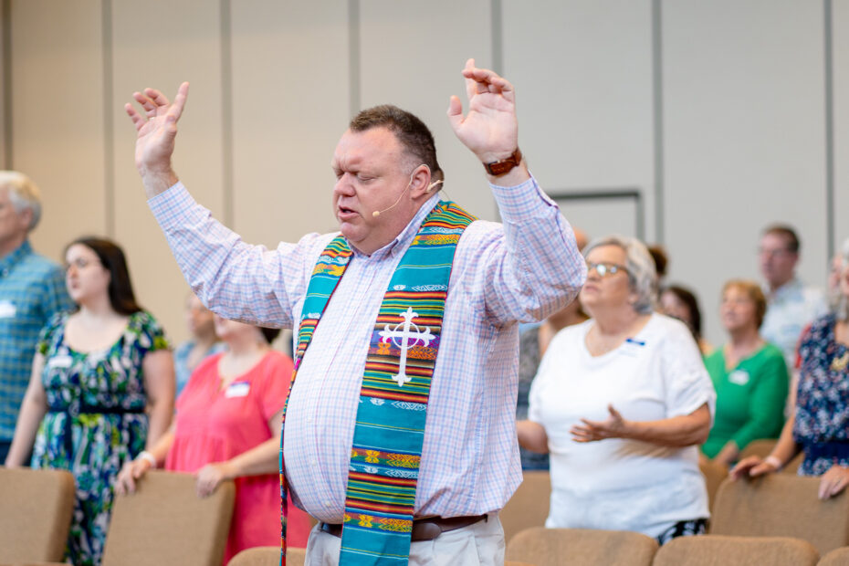 Pastor Mike Zdorow worshipping with church attendees at The Gathering Place Church in Palm Beach Gardens